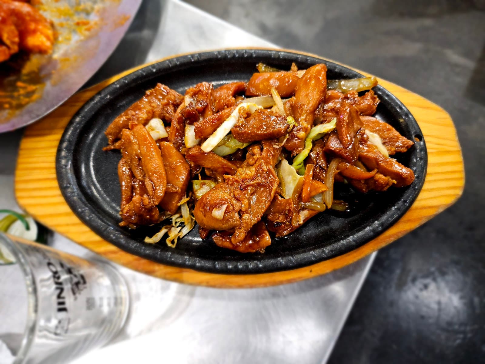 Premium beef cuts grilling on live-fire grill at Kogiya