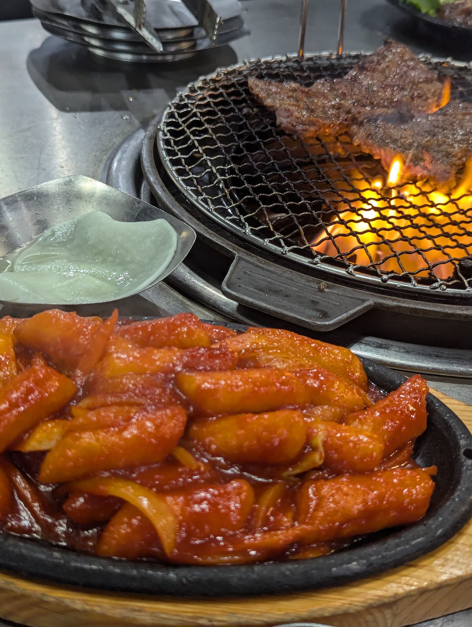 Marinated short ribs and pork belly on the grill at Kogiya Korean BBQ